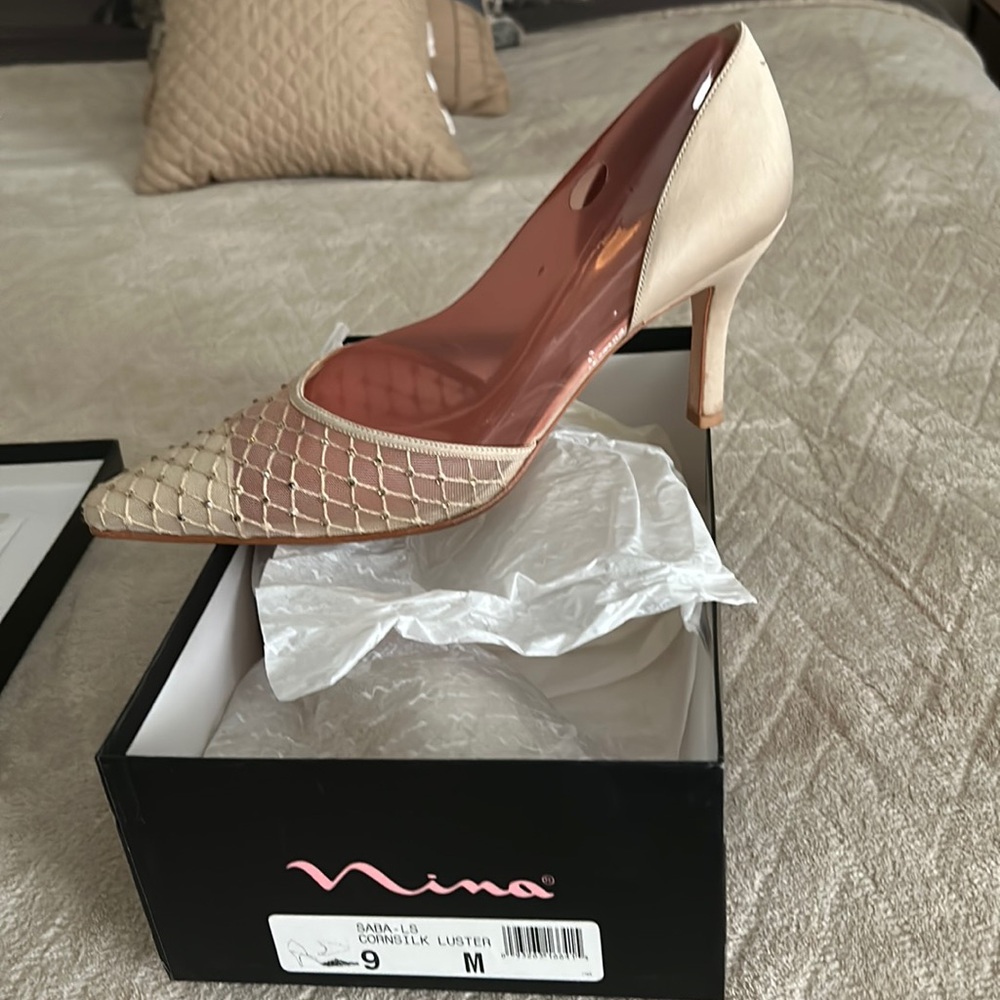 Silk heels with rhinestone netting over the toes.